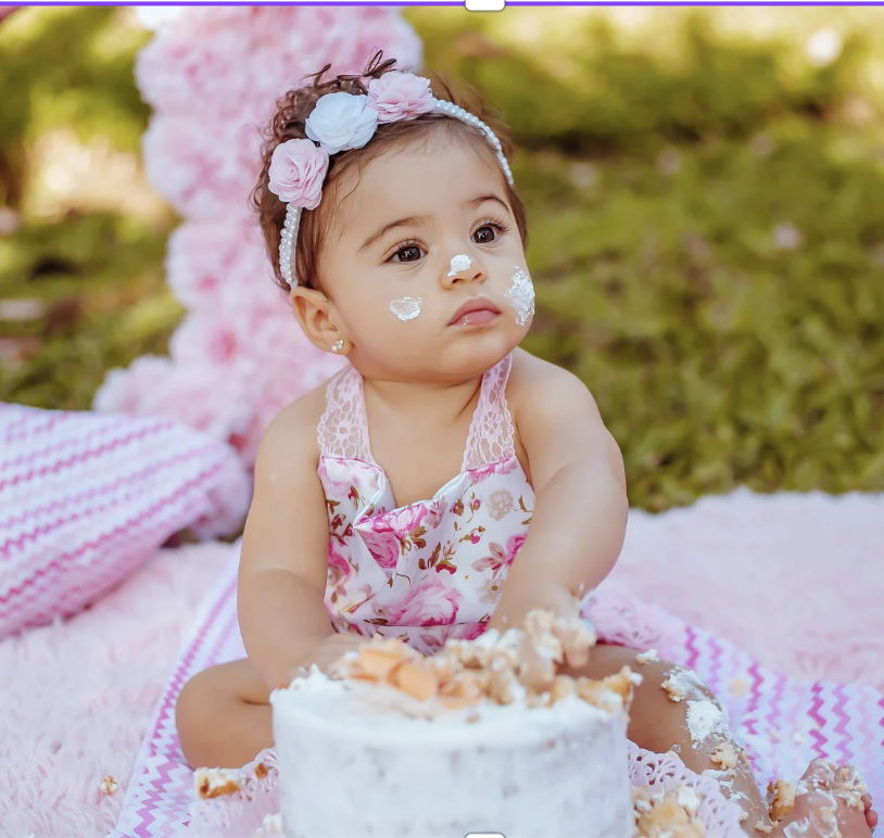 Baby at her first birthday cake smash