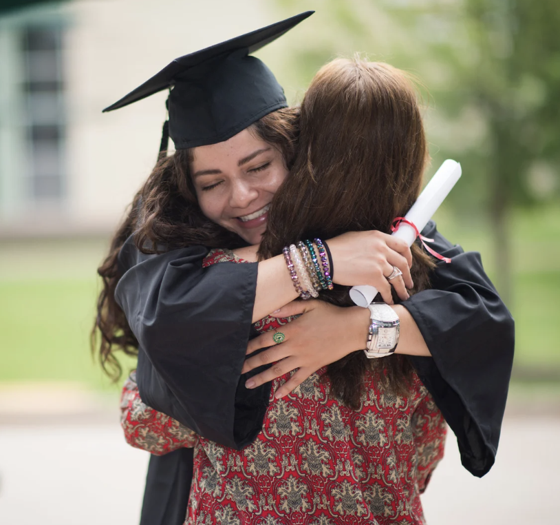 Graduate hugging her mother on graduation day