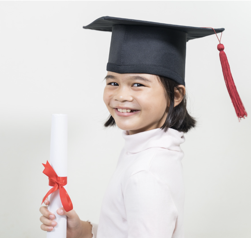 Young girl smiling in a graduation cap holding a diploma